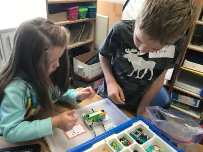 students building with legos