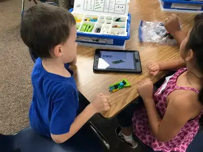 students building with legos