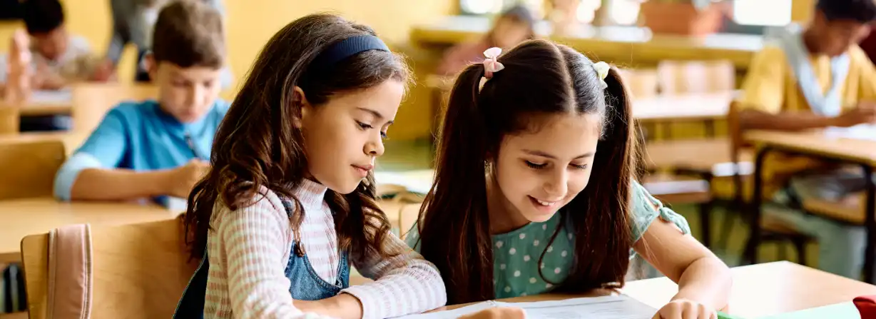 Happy school girls learning.